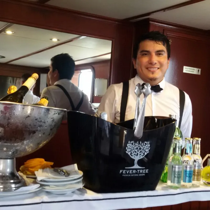 a person standing next to a blender