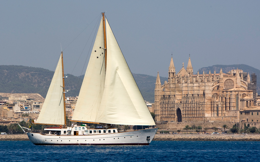 a large white boat sitting next to a body of water