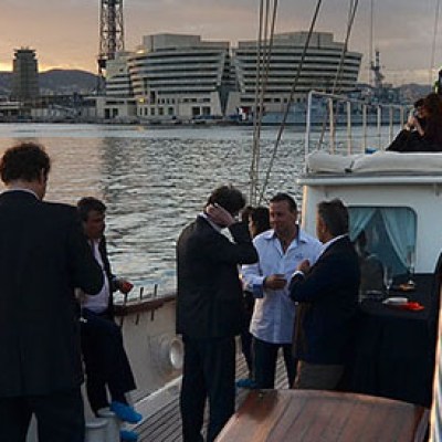 a group of people standing in front of a large ship in the water