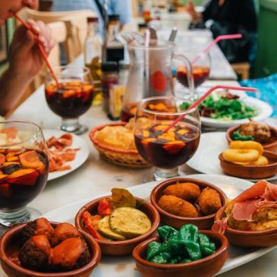 a group of people sitting at a table with a plate of food