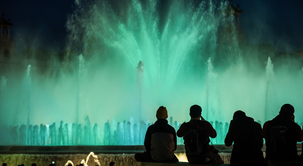 a group of people standing in front of water