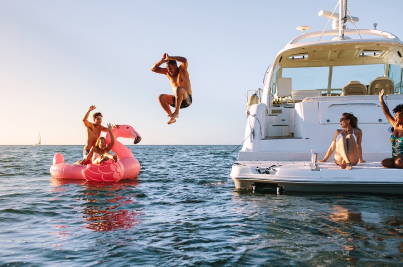 things to do on a boat a group of people riding on the back of a boat in the water