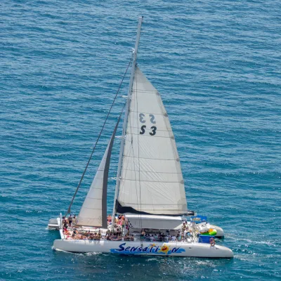 a blue and white boat floating on a body of water