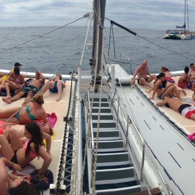 a group of people sitting in a boat on a body of water