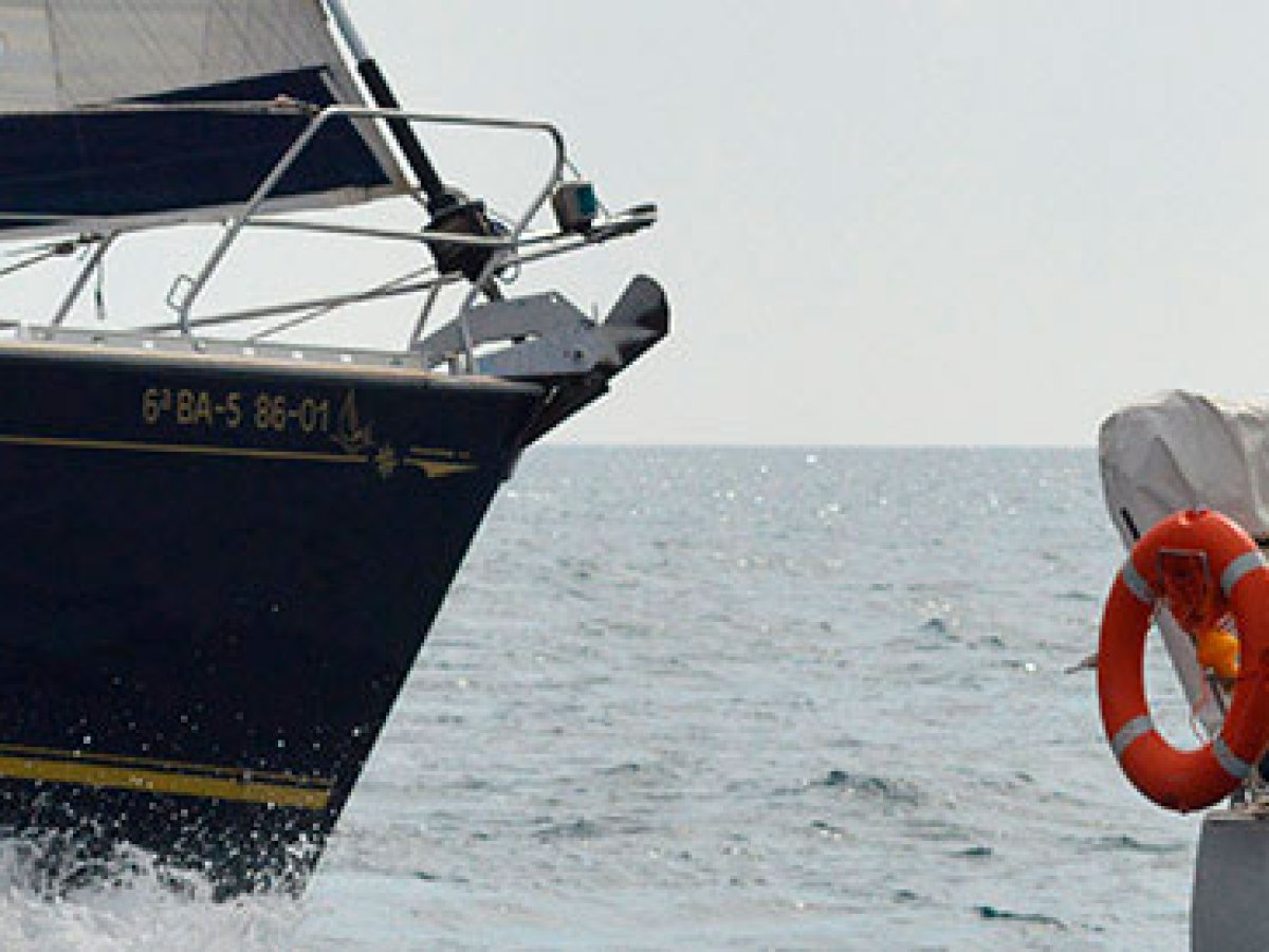 a man riding on the back of a boat in the water