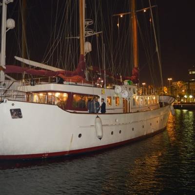 a boat is docked next to a body of water in Barcelona harbor