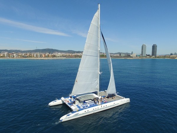 Orsom catamaran sailing in front of Barcelona
