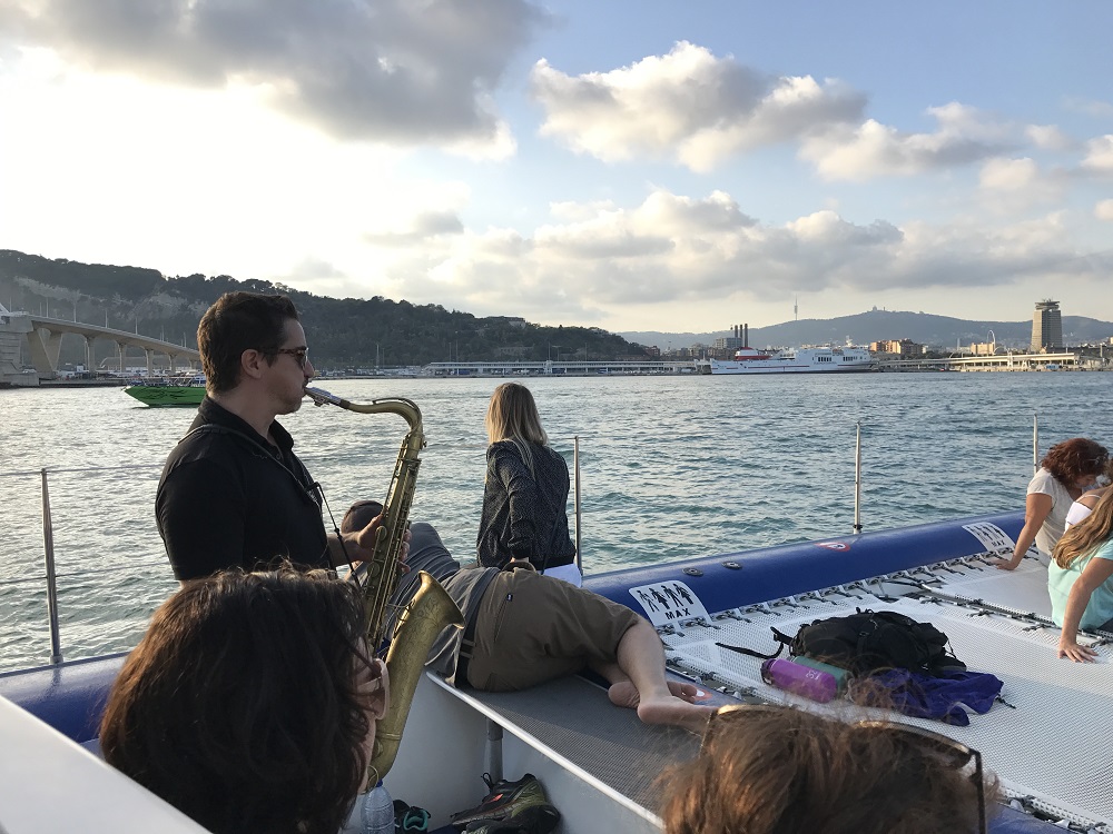 a group of people sitting in a boat on a body of water
