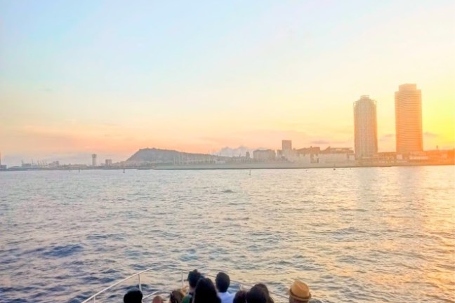 a group of people standing next to a body of water