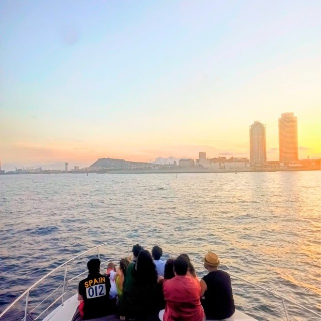 a group of people standing next to a body of water