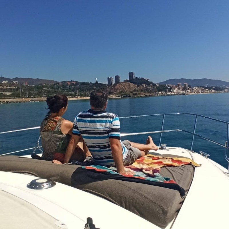 a man sitting next to a body of water