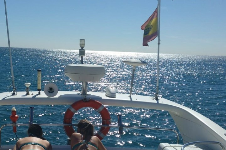 a group of people in a boat on a body of water
